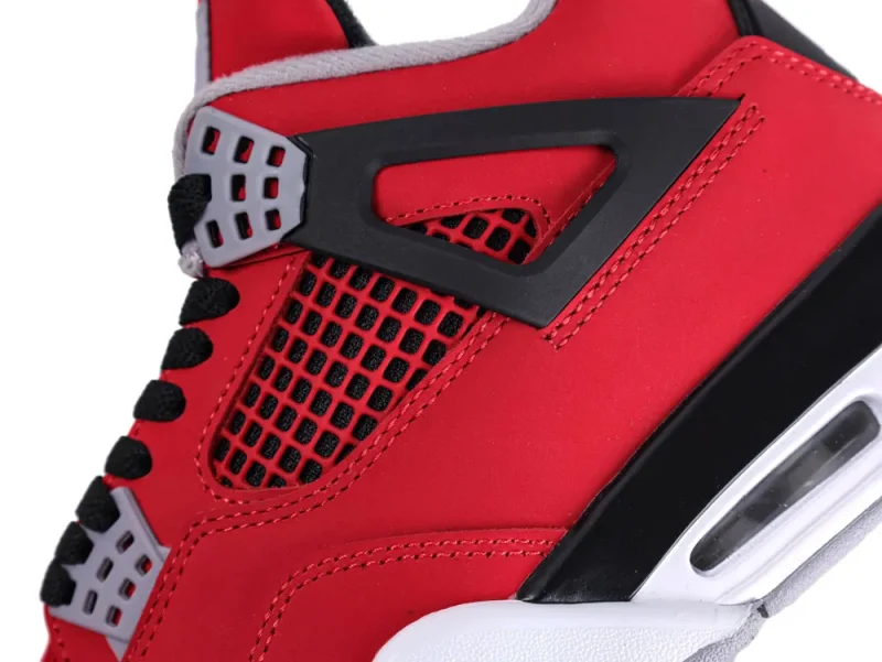 Red leather sneaker with black mesh detailing and gray plastic accents.