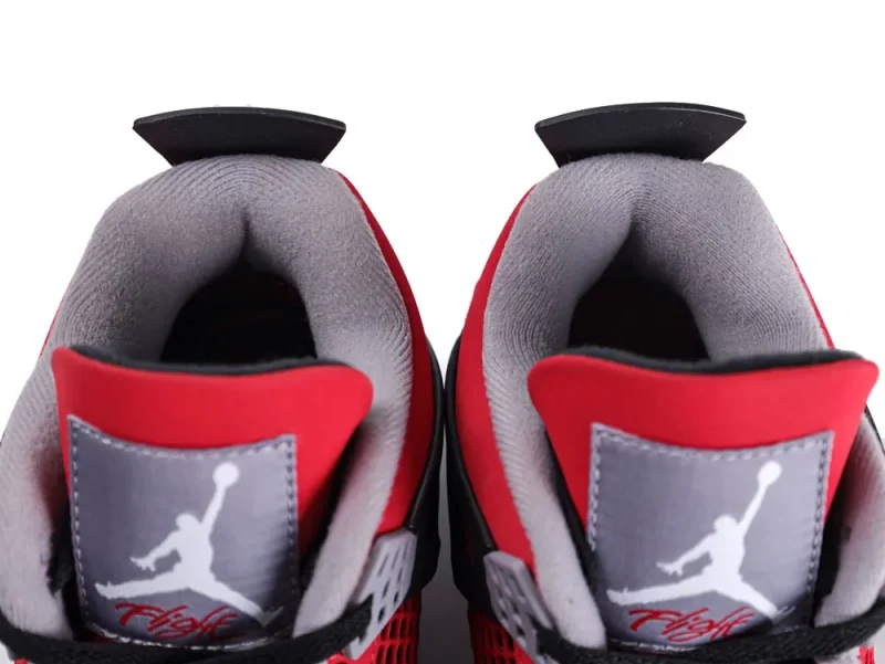 Red and grey sneakers with soft fabric interior and prominent logo on tongue.