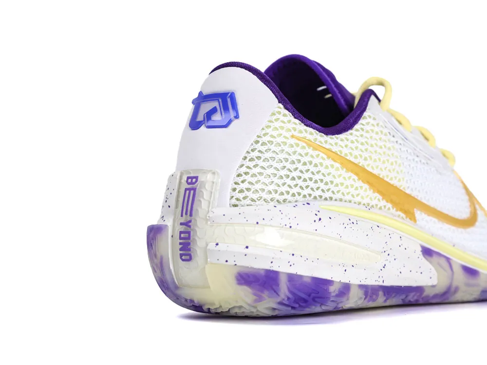 White mesh shoe with purple accents and a yellow swoosh, viewed from behind.