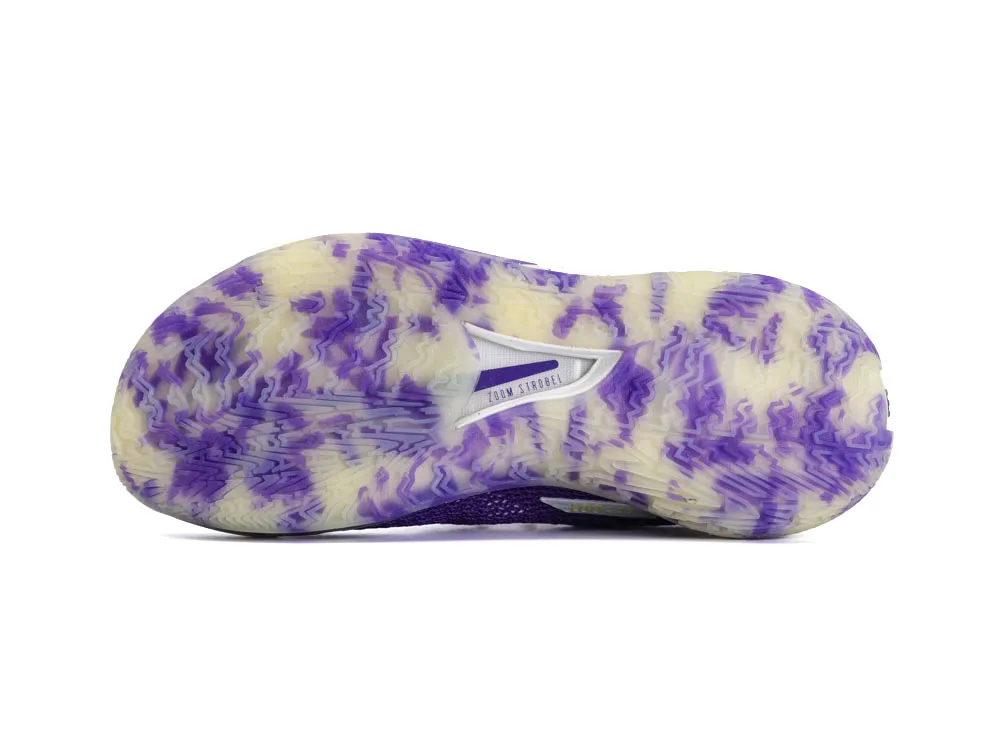 Purple and cream rubber sole with textured pattern and visible support structure.