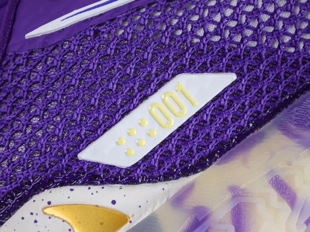 Close-up of a purple mesh and white sneaker with yellow laces and detailing.