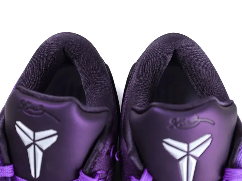 Purple fabric sneakers with padded collars and white logo on tongue.