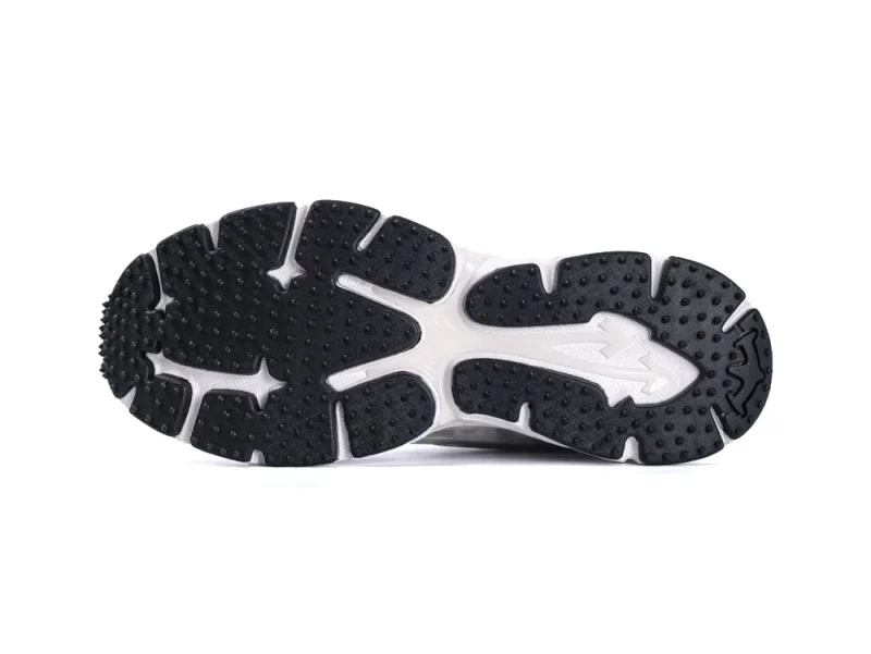 Black and white rubber sneaker sole with textured grip and unique pattern design.