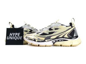 Beige and black sneakers with mesh fabric, featuring chunky, cushioned soles.