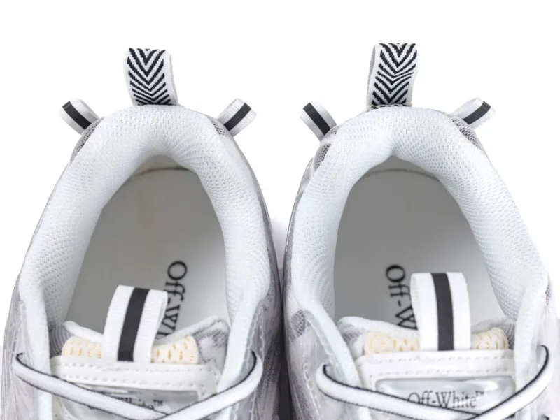 White and gray mesh sneakers with black-striped loop at the heel for easy pull-on.