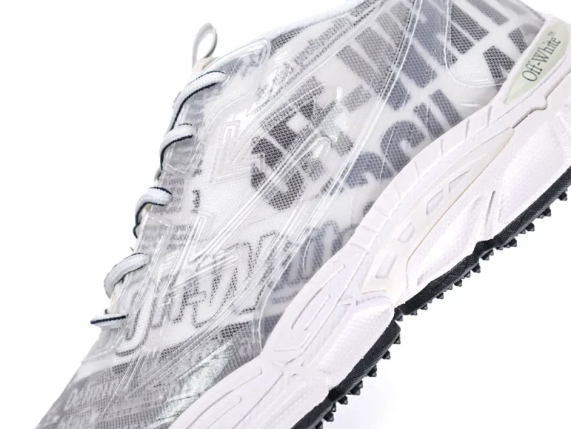 White and gray sneaker with translucent material and black textured rubber sole.