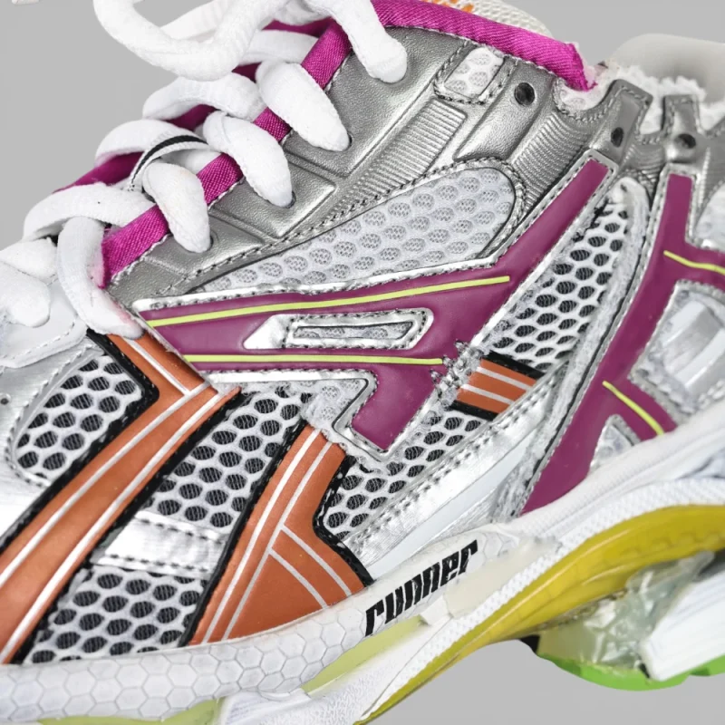 Close-up of a multi-colored sneaker with mesh fabric and rubber detailing.