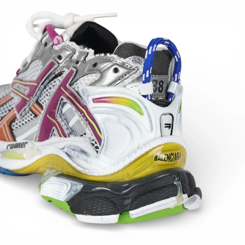 Multicolored sneaker featuring mesh and leather materials with a unique sole design.