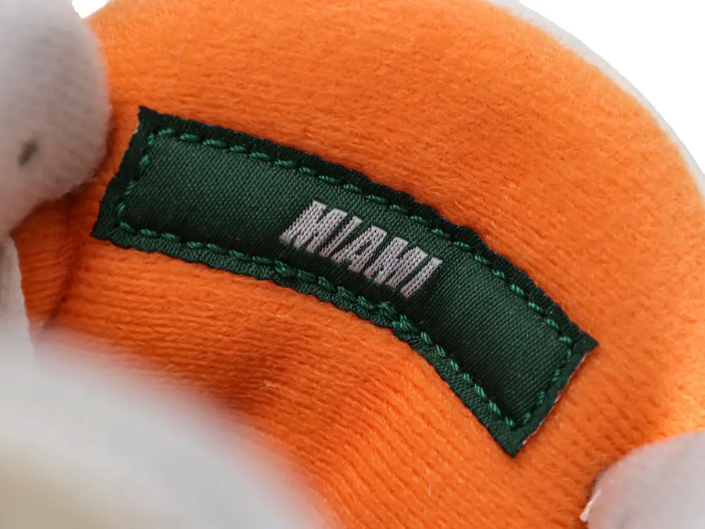 Orange fabric interior with a green embroidered label reading "Miami."