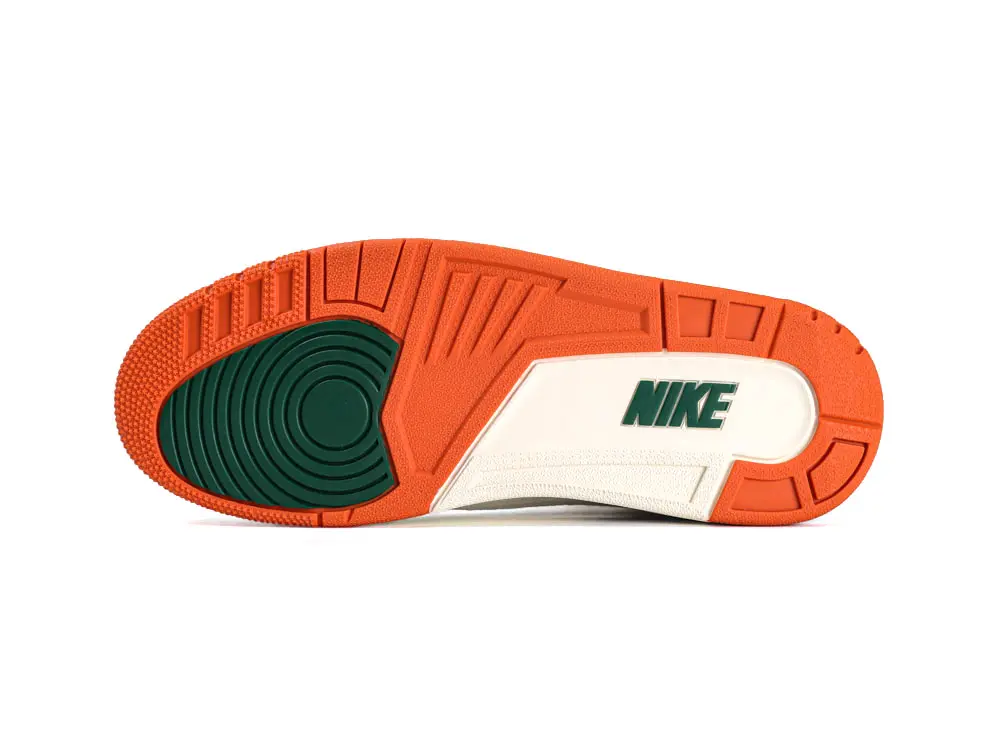 Orange and green rubber sole with textured grip and brand logo.