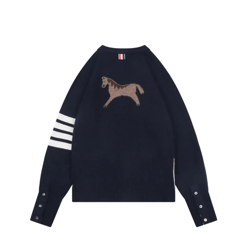 Bacl view of navy knit cardigan with four-bar stripe sleeve and button closure