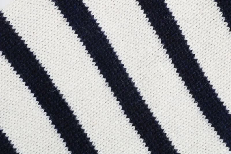 Four-bar stripe knit detail on navy cardigan sleeve