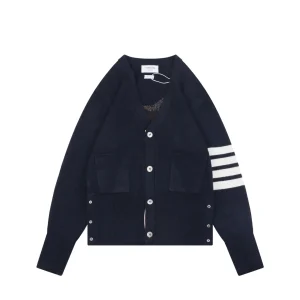 Front view of navy knit cardigan with four-bar stripe sleeve and button closure