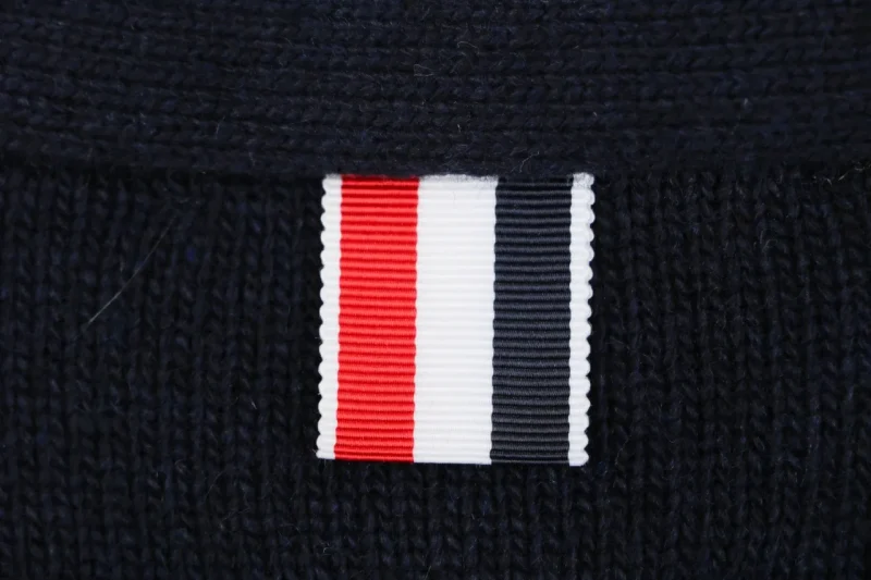 Tricolor grosgrain tab detail on navy knit cardigan