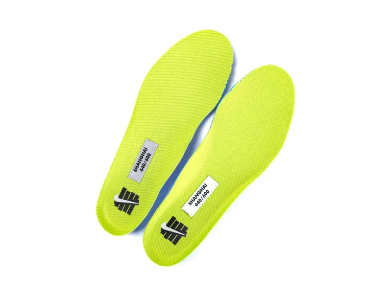 Bright yellow fabric insoles, with printed labels, feature textured material for comfort.