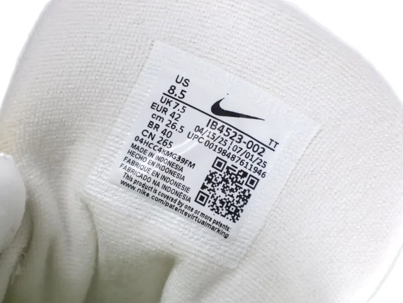 White fabric shoe interior with a Nike label displaying size and manufacturing details.
