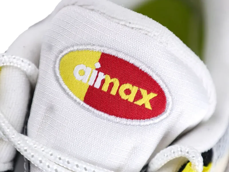 White fabric sneaker tongue with red and yellow "air max" logo.