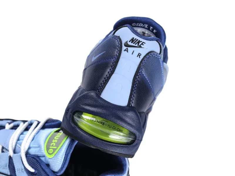 Blue and navy sneaker with mesh and leather upper, featuring visible green air unit.