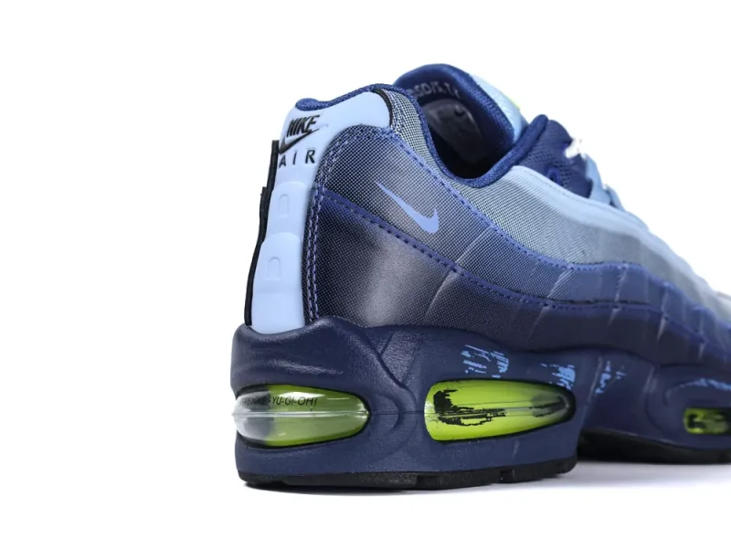 Blue mesh and synthetic sneaker with green air cushioning detail at heel.