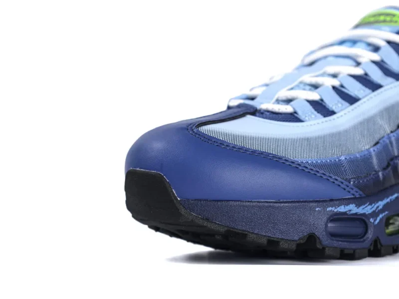 Blue leather and mesh sneaker, close-up of toe and laces.