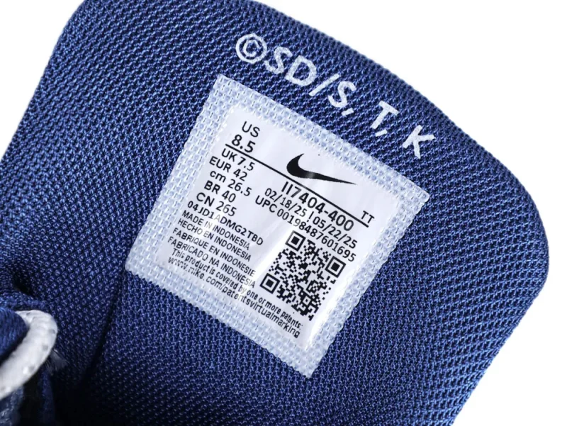 Blue fabric shoe tongue featuring a white label with printed product information.
