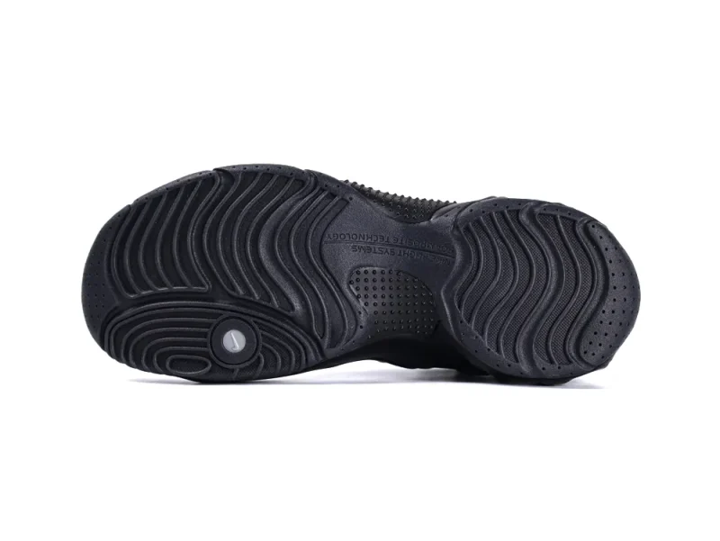 Black rubber sneaker sole with textured grip pattern, showing intricate design details.
