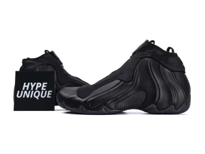 Black sneaker with a sleek design, featuring smooth synthetic material and textured sole.