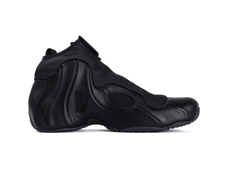 Black sneaker featuring a sleek leather body and fabric upper with mesh accents.