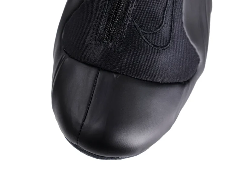 Black leather shoe with fabric upper and zipper detail on top.