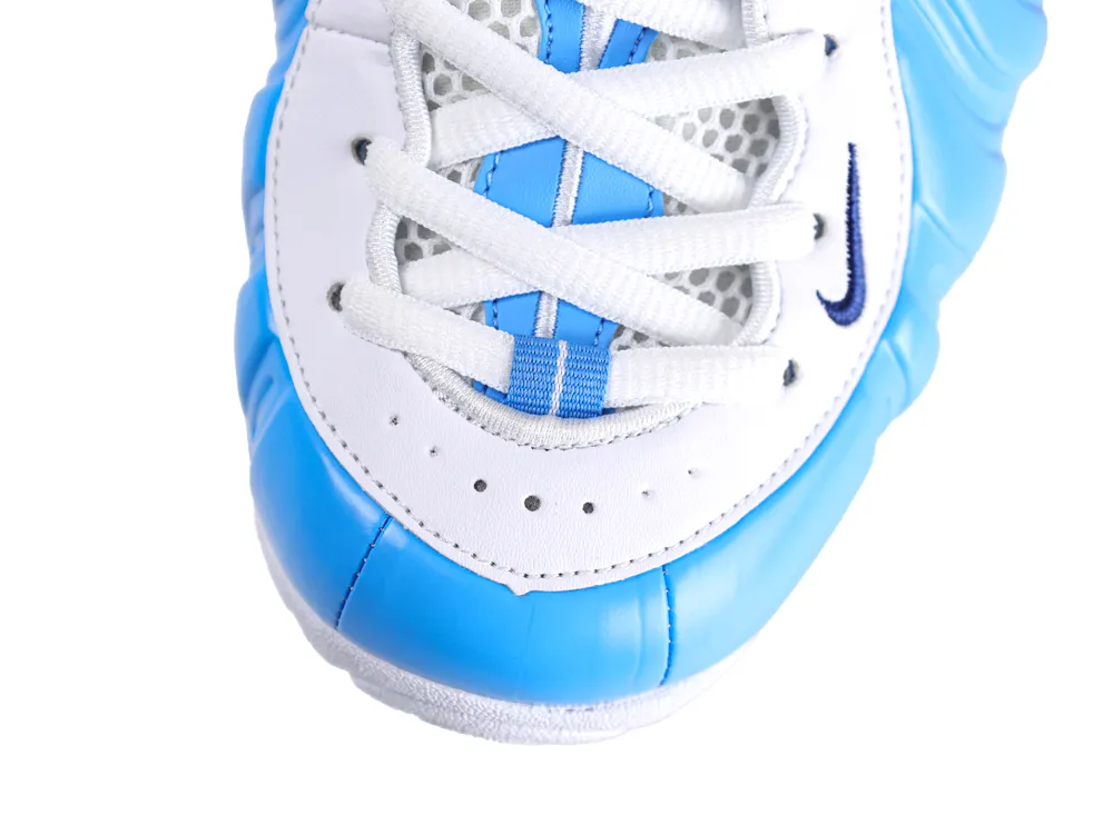 Close-up of blue and white sneaker, leather material, focusing on the toe area.