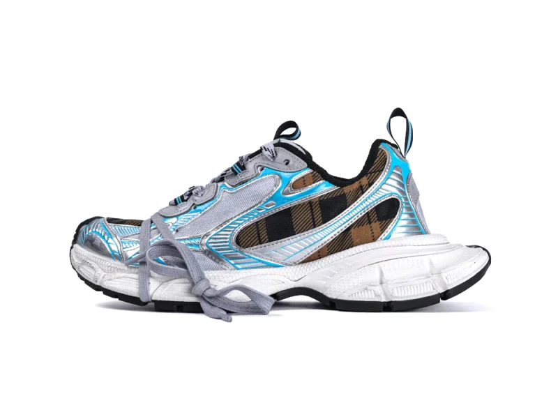 Silver and blue sneaker with plaid accents and chunky white sole.