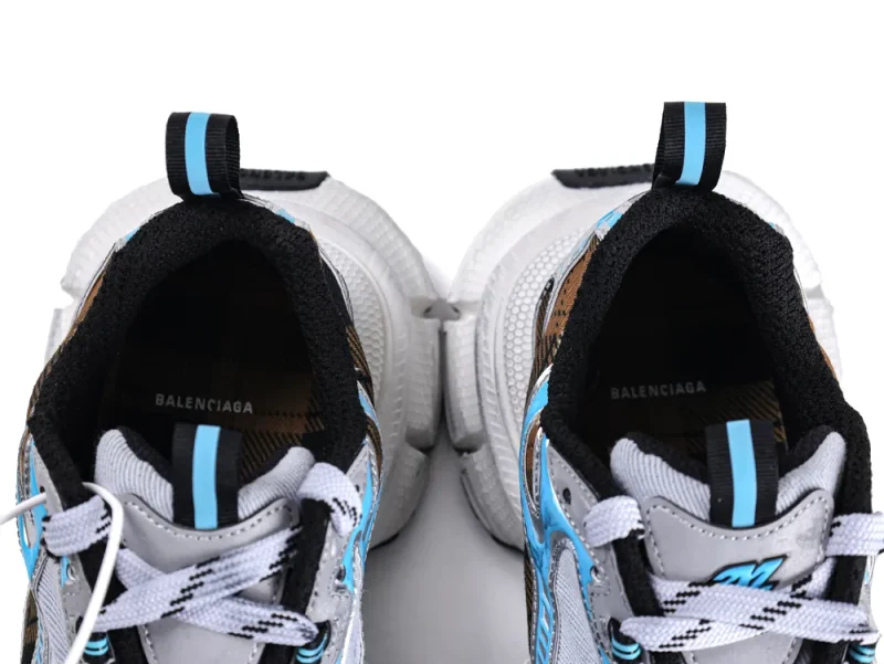 Gray sneakers with blue accents, featuring a white rubber sole and black lining.