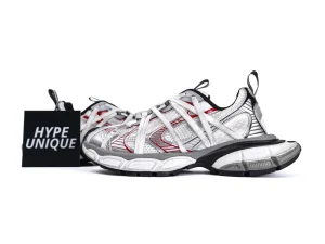 Silver and red sneakers with mesh uppers and sturdy black and white soles.