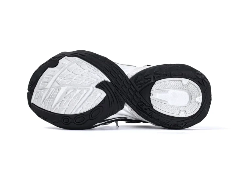 Black and white rubber sneaker sole with textured tread pattern.