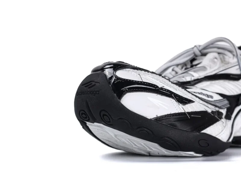 White and black sneaker toe detail with rubber sole and mesh material.