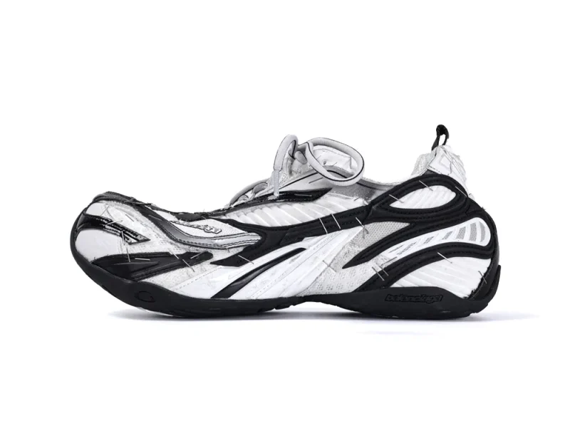 White and black mesh athletic shoe with intricate detailing and textured sole.
