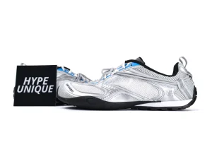 Silver mesh sneakers with metallic accents and rubber sole, displayed next to "Hype Unique" sign.