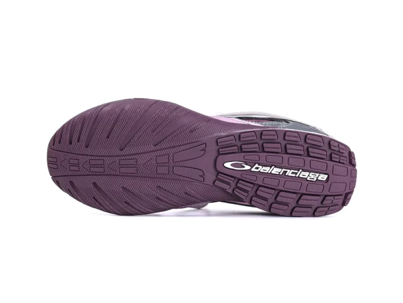 Purple rubber sole of a shoe with logo, textured for grip.