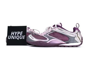 Purple and pink sneakers with mesh and leather material, showcasing intricate side detailing.