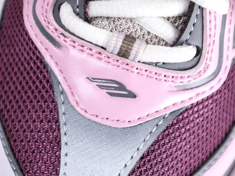 Pink, grey, and maroon mesh sneaker upper with white laces and logo detail.