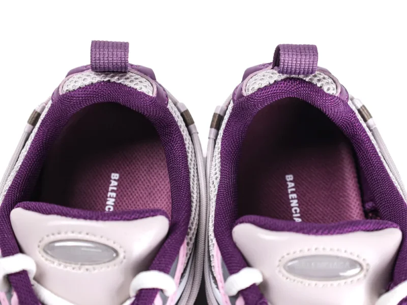 Top view of purple and white sneakers with mesh fabric and laces visible.