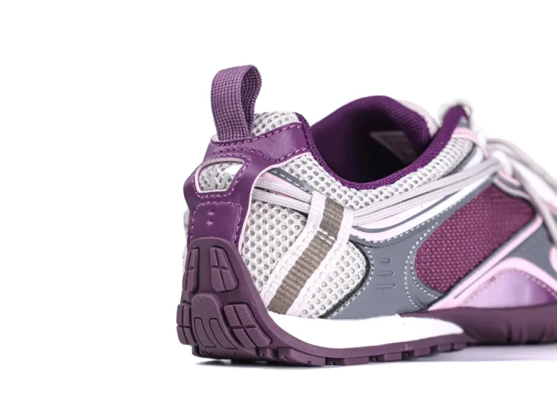 Purple and white mesh sneaker with textured sole and pull tab at heel.