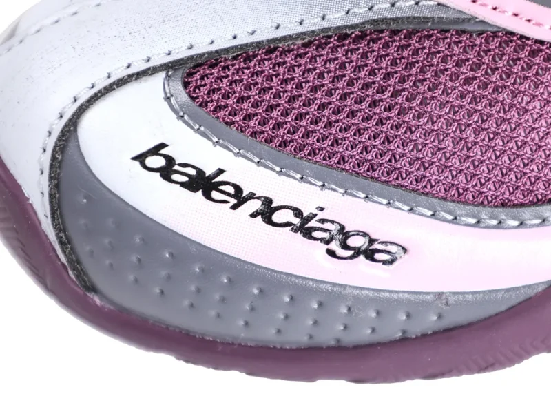 Purple and grey sneaker with white leather and mesh details, featuring textured stitching.