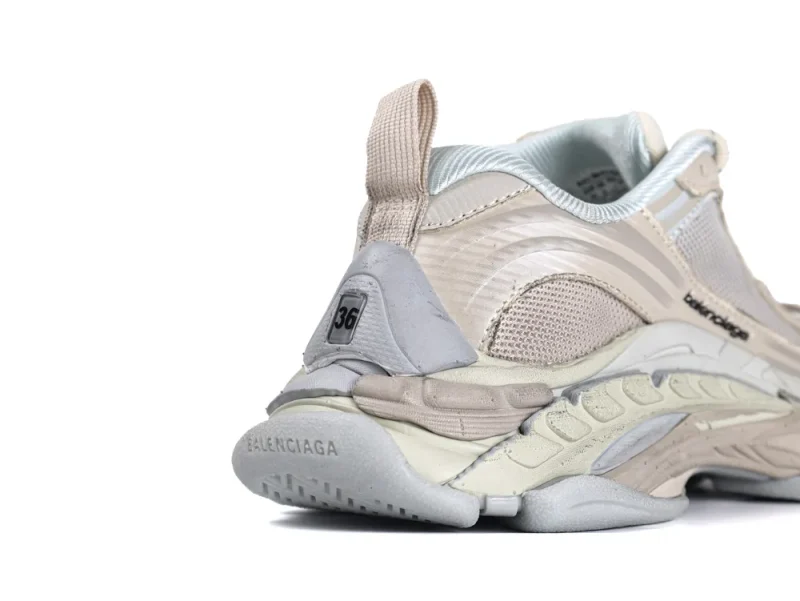 Tan and gray sneaker with mesh and synthetic materials showing heel and sole.