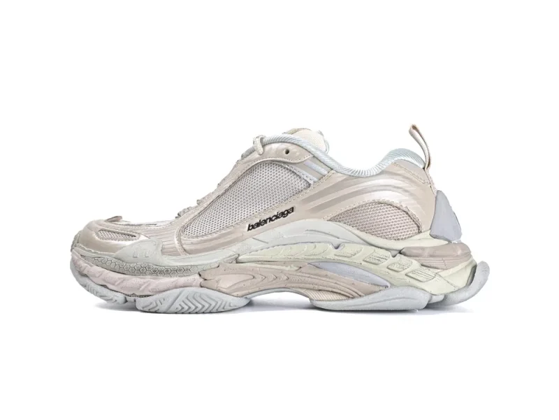 Beige sneaker with mesh and leather, featuring a textured, sculpted rubber sole.