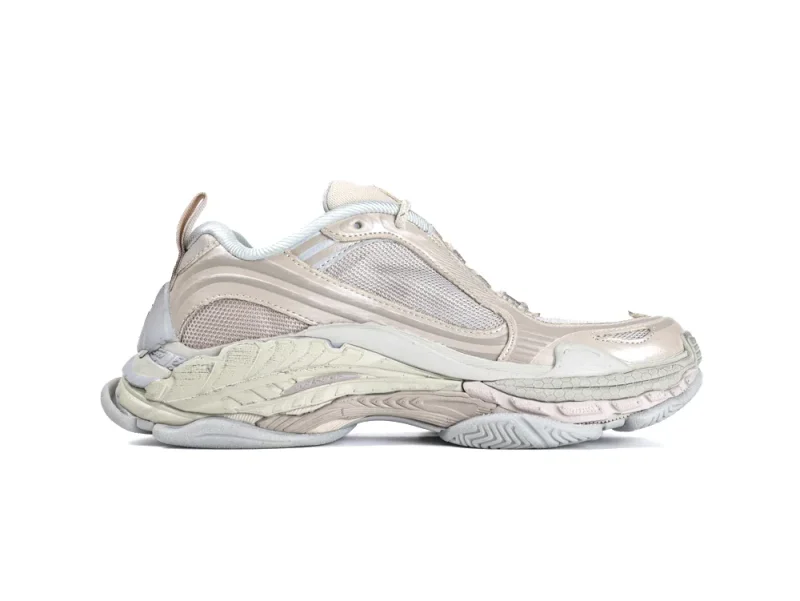 Beige sneaker with a mesh and leather upper, featuring a textured rubber sole.