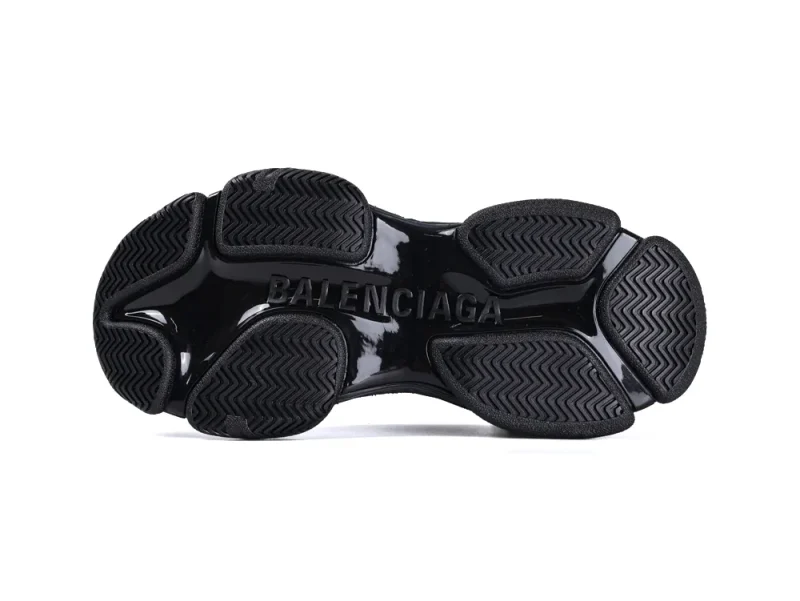 Black rubber sole with textured grip, featuring embossed brand name.