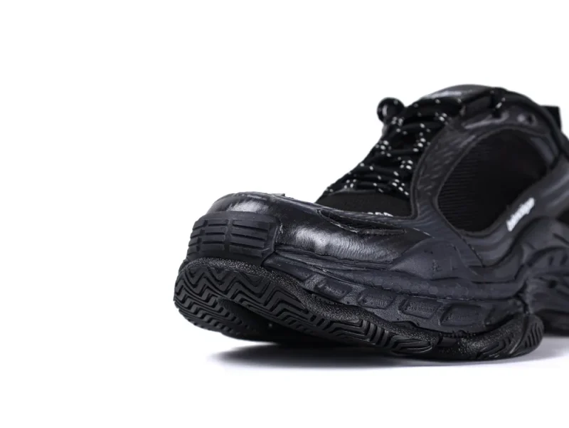 Black sneaker with rubber sole and mesh upper for durability and comfort.