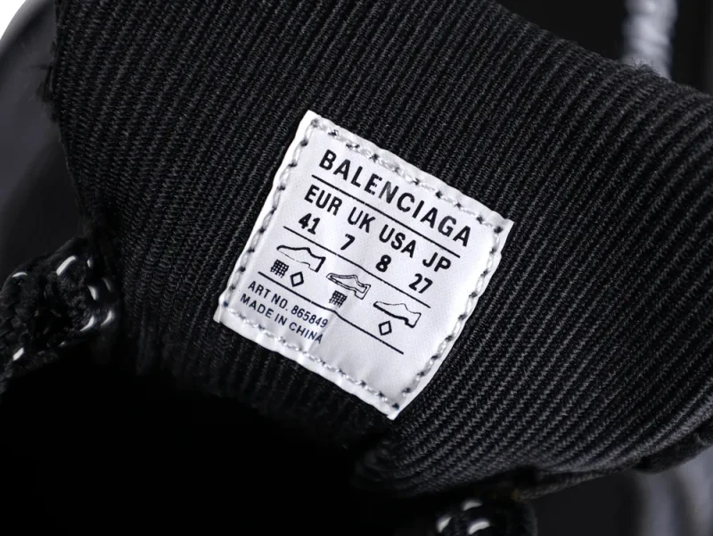 Black fabric shoe tongue with white label displaying sizing and brand information.