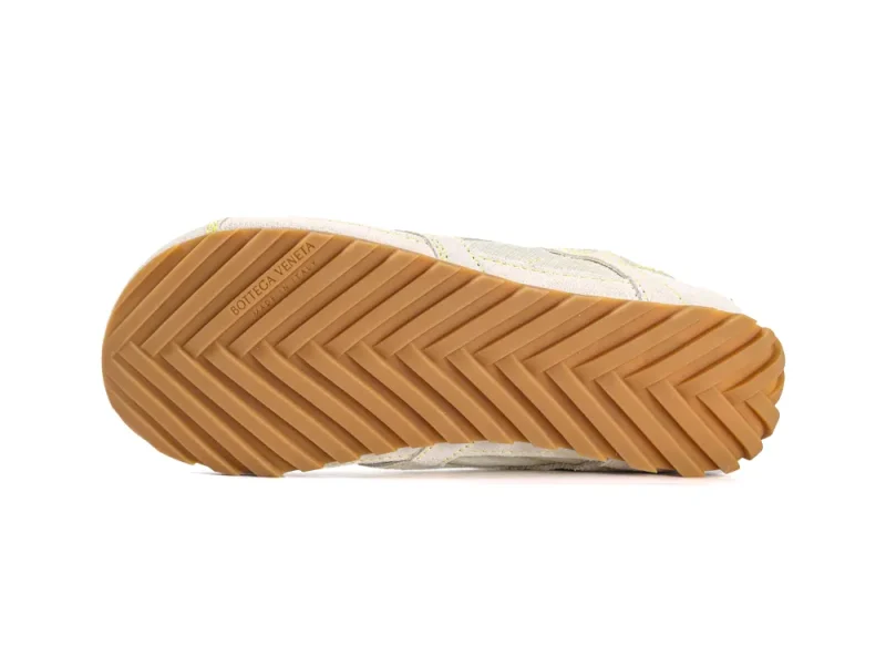 Tan rubber sole with herringbone pattern, imprinted with brand and "Made in Italy".